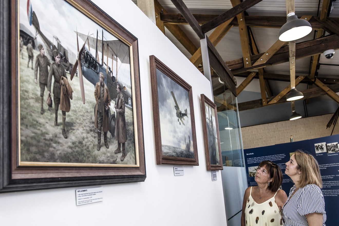Graham Turner's original artwork The Replacements is admired by Lynne and Karen at Stow Maries Great War Aerodrome by David Davies